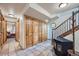 Welcoming hallway with tile flooring, wood accents, storage closet, and staircase to the second floor at 5739 Highway 9, Breckenridge, CO 80424