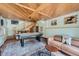 Recreation room featuring an air hockey table, cozy couch, and rustic wood ceiling detail at 5739 Highway 9, Breckenridge, CO 80424
