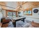 Spacious recreation room includes wood ceilings, air hockey table, and scenic outdoor views at 5739 Highway 9, Breckenridge, CO 80424
