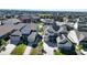 A high angle shot of a house with solar panels and a well-manicured lawn, nestled in a vibrant community with beautiful driveways at 8867 S Zante St, Aurora, CO 80016