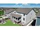 A high angle shot of a house with beautiful backyard including a deck and firepit, nestled in a vibrant community with mountain views at 8867 S Zante St, Aurora, CO 80016