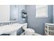Powder room features blue walls, a white pedestal sink, and updated fixtures at 8867 S Zante St, Aurora, CO 80016