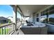 A cozy, covered patio with a wicker seating area, perfect for outdoor lounging and entertaining with large windows and sunny views at 8867 S Zante St, Aurora, CO 80016