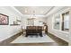 Dining room with tray ceiling, modern chandelier, hardwood floors, and large window at 8867 S Zante St, Aurora, CO 80016