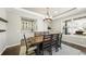 Bright dining room with built in bar, large wood table and upholstered chairs at 8867 S Zante St, Aurora, CO 80016