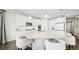 Bright, open kitchen with white cabinetry, large island with seating, and stainless appliances at 8867 S Zante St, Aurora, CO 80016