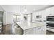 Bright eat-in kitchen features a large island with seating and modern white cabinetry at 8867 S Zante St, Aurora, CO 80016