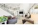 Spacious living room with soaring ceilings, wrought iron staircase, and a cozy fireplace at 8867 S Zante St, Aurora, CO 80016