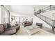 Open-concept living room with staircase, hardwood floors, and view of kitchen and dining area at 8867 S Zante St, Aurora, CO 80016