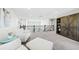 Spacious loft with plush carpeting, comfortable seating, and stylish barn door feature at 8867 S Zante St, Aurora, CO 80016