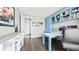 Bright office with custom blue built-ins, a spacious desk, and hardwood floors at 8867 S Zante St, Aurora, CO 80016