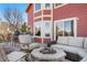 Spacious back deck with fire pit, outdoor seating, and a well-maintained lawn at 1621 Beacon Hill Dr, Highlands Ranch, CO 80126