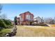 Expansive backyard features a deck, mature trees, and a charming stone retaining wall at 1621 Beacon Hill Dr, Highlands Ranch, CO 80126