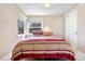 Cozy bedroom featuring natural light, neutral colors, and a closet, creating a simple and relaxing space at 1621 Beacon Hill Dr, Highlands Ranch, CO 80126