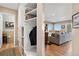 Hallway with storage leading to living room with view of backyard at 1621 Beacon Hill Dr, Highlands Ranch, CO 80126