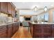 Open-concept kitchen featuring a granite countertop island and seamless flow to the living area at 1621 Beacon Hill Dr, Highlands Ranch, CO 80126