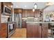 Modern kitchen with stainless steel appliances, hardwood floors, and a spacious center island at 1621 Beacon Hill Dr, Highlands Ranch, CO 80126