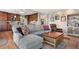 Comfortable living area adjacent to the kitchen with a gray sofa and wooden coffee table at 1621 Beacon Hill Dr, Highlands Ranch, CO 80126