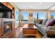 Cozy living room featuring a fireplace, built-in shelving, and sliding doors to the outside at 1621 Beacon Hill Dr, Highlands Ranch, CO 80126