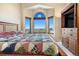 Bright main bedroom featuring large windows with a stained glass accent and views at 1621 Beacon Hill Dr, Highlands Ranch, CO 80126