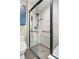 Modern bathroom featuring a glass-enclosed shower with white textured tile and sleek fixtures at 1621 Beacon Hill Dr, Highlands Ranch, CO 80126