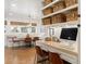 Kitchen nook with built-in banquette seating and light wood desk at 7205 S Newport Way, Centennial, CO 80112