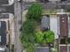 An aerial view of a home with a gray roof and surrounding trees offering privacy in a neighborhood setting at 1707 W 39Th Ave, Denver, CO 80211