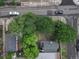 A bird's eye view reveals a house with greenery, showcasing its neighborhood placement and tree coverage at 1707 W 39Th Ave, Denver, CO 80211