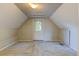 Finished attic boasts carpet, white trim, and an exterior door with a window at 1707 W 39Th Ave, Denver, CO 80211