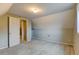 Cozy attic with carpet flooring, neutral walls, and an entry door with white trim at 1707 W 39Th Ave, Denver, CO 80211