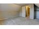 Neutral attic space with carpet, closet, and an entryway with a door and trim at 1707 W 39Th Ave, Denver, CO 80211