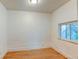 This cozy bedroom features hardwood floors, a window for natural light, and neutral walls at 1707 W 39Th Ave, Denver, CO 80211