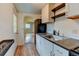 Well-lit kitchen with modern appliances, white cabinets, and wood-look flooring at 1707 W 39Th Ave, Denver, CO 80211