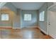 Open living room boasts hardwood floors, neutral paint, and natural light from the many windows at 1707 W 39Th Ave, Denver, CO 80211