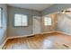 Open living area featuring hardwood floors, multiple windows, and direct outdoor access at 1707 W 39Th Ave, Denver, CO 80211
