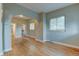 Spacious living area featuring hardwood floors, arched doorway, and natural light from multiple windows at 1707 W 39Th Ave, Denver, CO 80211