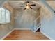 The living area includes hardwood floors, a ceiling fan, a staircase, and a large window for natural light at 1707 W 39Th Ave, Denver, CO 80211