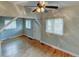 Bright living room features hardwood floors, light-colored walls, and a ceiling fan at 1707 W 39Th Ave, Denver, CO 80211