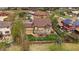 Aerial view of a home featuring a well-manicured lawn, patio, and mature trees at 15258 W 75Th Pl, Arvada, CO 80007