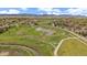 Neighborhood with a large green space featuring ponds, walking paths, and community amenities at 15258 W 75Th Pl, Arvada, CO 80007