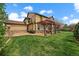 Expansive backyard with a well-maintained lawn, patio, pergola, and mature landscaping at 15258 W 75Th Pl, Arvada, CO 80007