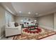 Finished basement features plush sofas, a decorative rug, and custom artwork at 15258 W 75Th Pl, Arvada, CO 80007