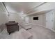 Comfortable basement rec room with ample seating and a flat screen television at 15258 W 75Th Pl, Arvada, CO 80007