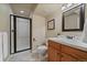 Bathroom offers a tiled shower with glass door and updated vanity at 15258 W 75Th Pl, Arvada, CO 80007
