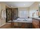 Modern bathroom showcasing a soaking tub, a glass shower, and stylish tile work at 15258 W 75Th Pl, Arvada, CO 80007