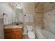 Well-lit bathroom with a granite vanity, a mirror, and a shower over tub setup at 15258 W 75Th Pl, Arvada, CO 80007