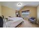 Cozy bedroom with a vaulted ceiling, a comfortable chair, and a bright window at 15258 W 75Th Pl, Arvada, CO 80007