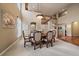 Elegant dining room featuring a large table, staircase, and arched doorway, perfect for gatherings at 15258 W 75Th Pl, Arvada, CO 80007