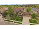 Stunning exterior view of a well-maintained home with lush landscaping and a three-car garage at 15258 W 75Th Pl, Arvada, CO 80007