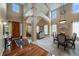 Grand foyer with soaring ceilings, hardwood floors, decorative columns, and lots of natural light at 15258 W 75Th Pl, Arvada, CO 80007